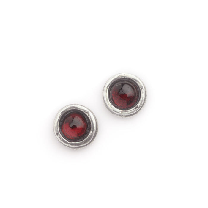 Pair of silver earrings with red gemstones on a white background