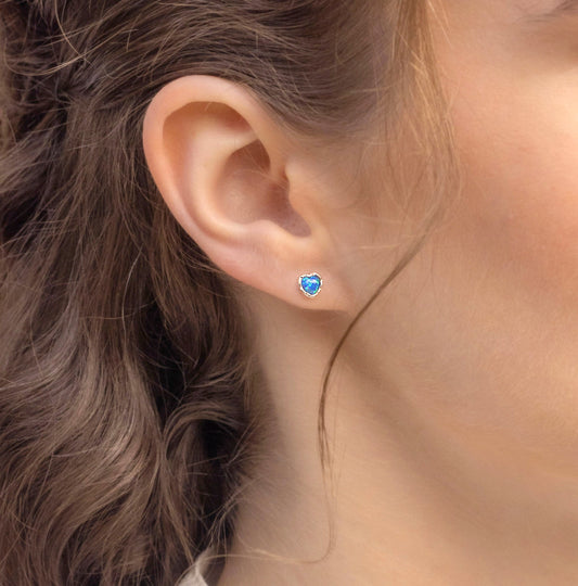 Close-up of an ear wearing a Small Sterling Silver Opalite Heart Studs