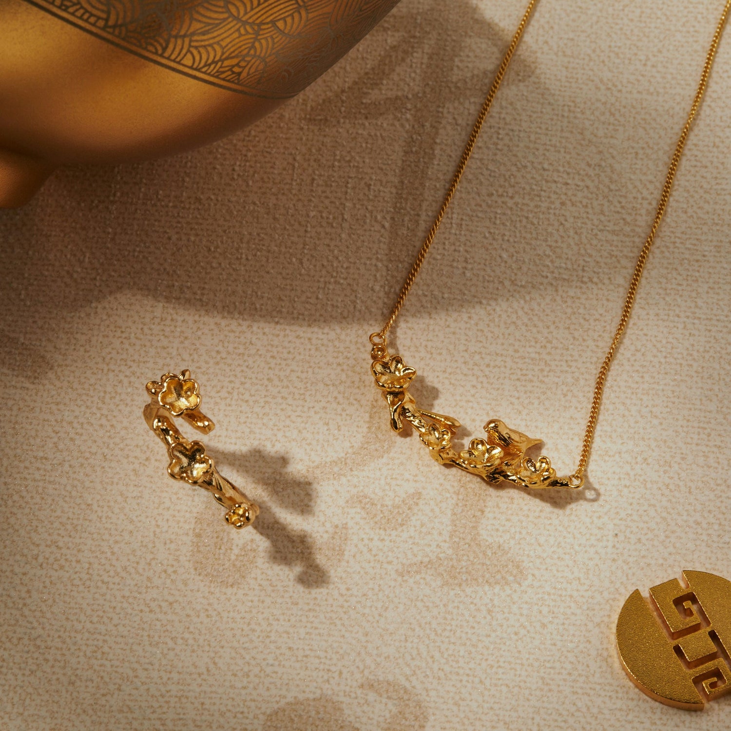 Gold necklaces and pendants spilling from a jewellery box