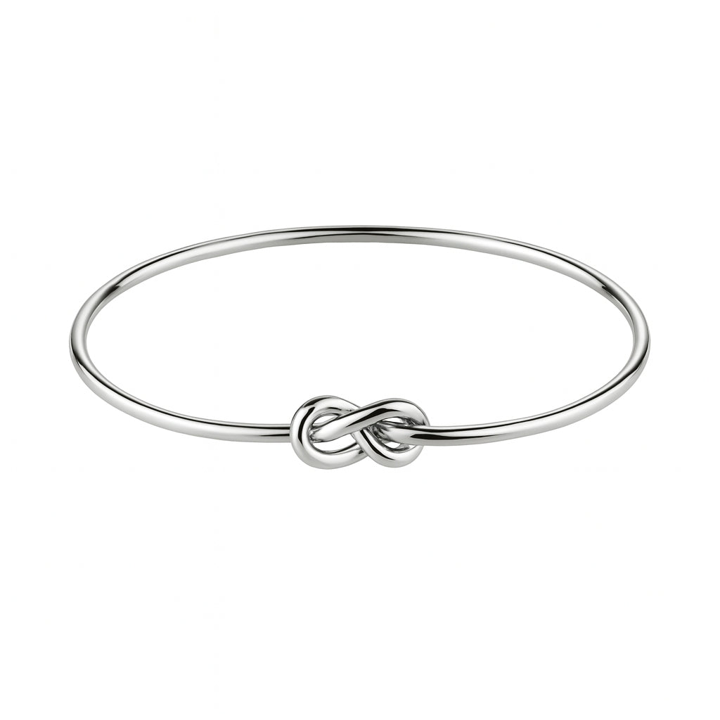 Silver bracelet with a knot design on a white background