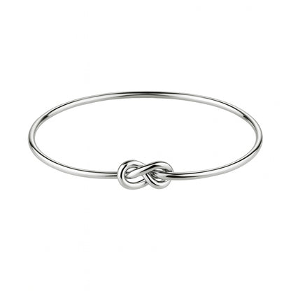 Silver bracelet with a knot design on a white background