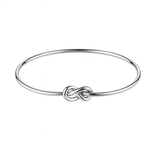 Silver bracelet with a knot design on a white background