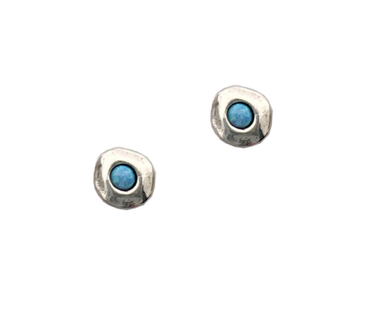 Pair of silver earrings with blue gemstones on a white background