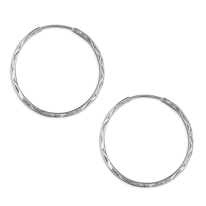 Pair of silver hoop earrings on a white background