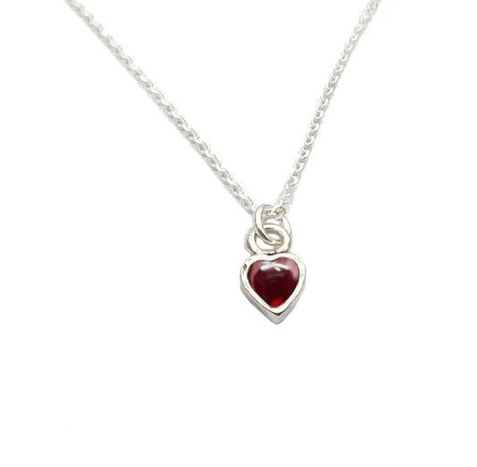 sterling silver, this heart necklace features a striking garnet stone at its centre, symbolising deep affection and passion