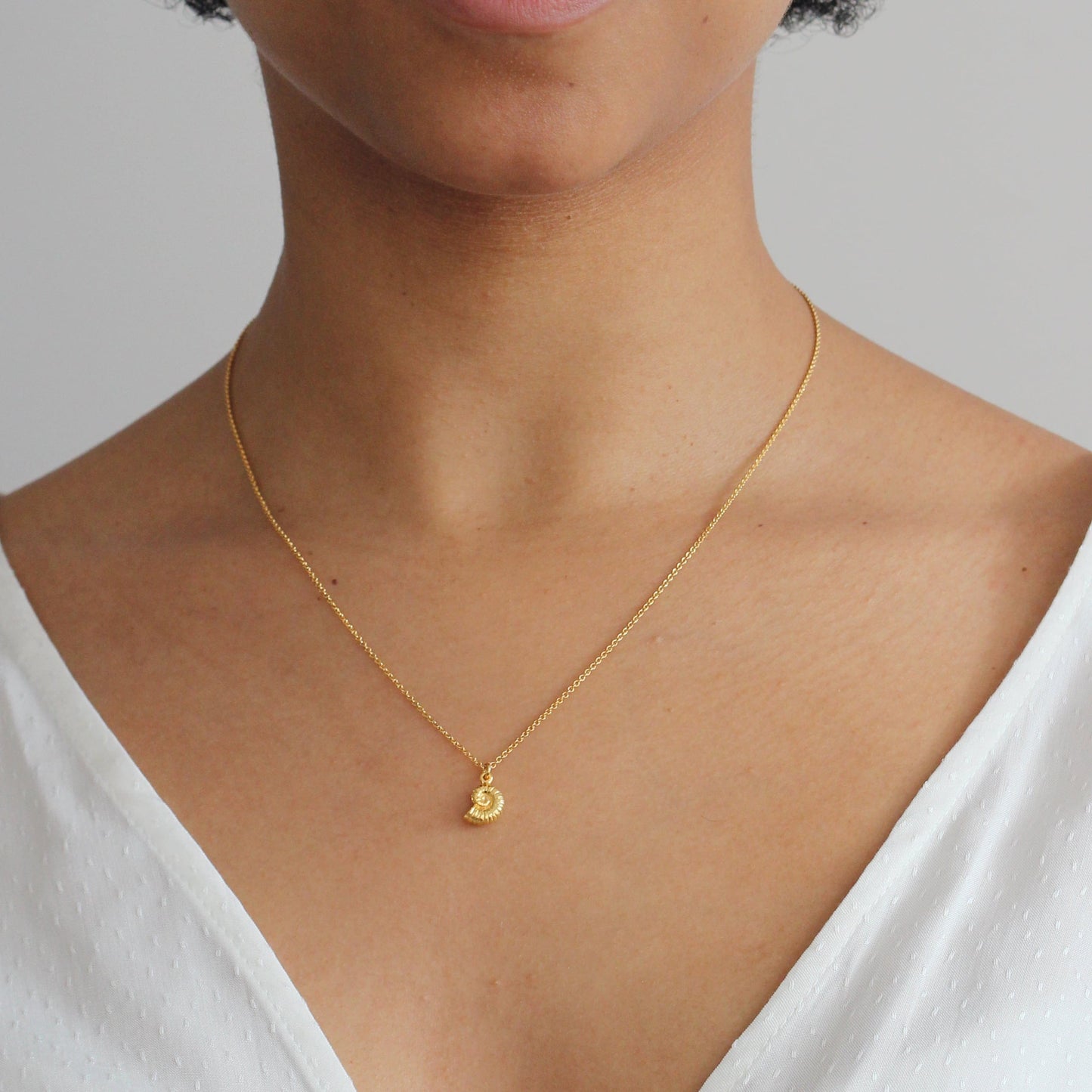 Alex Monroe 22 carat Gold Vermeil Ammonite Necklace worn by a model