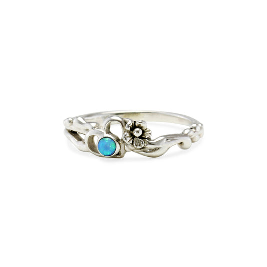 Dainty Sterling Silver open heart set with a blue opaline stone and a flower next to the heart