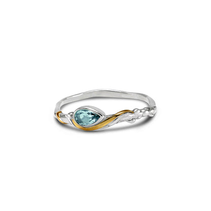 Dainty Sterling Silver ring set with a blue pear shape Blue Topaz and gold detail