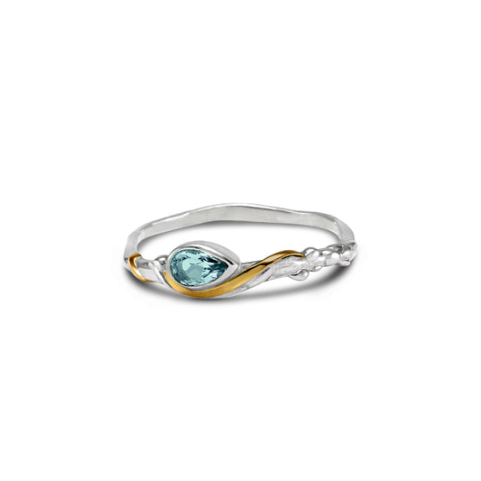 Dainty Sterling Silver ring set with a blue pear shape Blue Topaz and gold detail